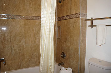 King guest bathroo with tub and shower combination.
